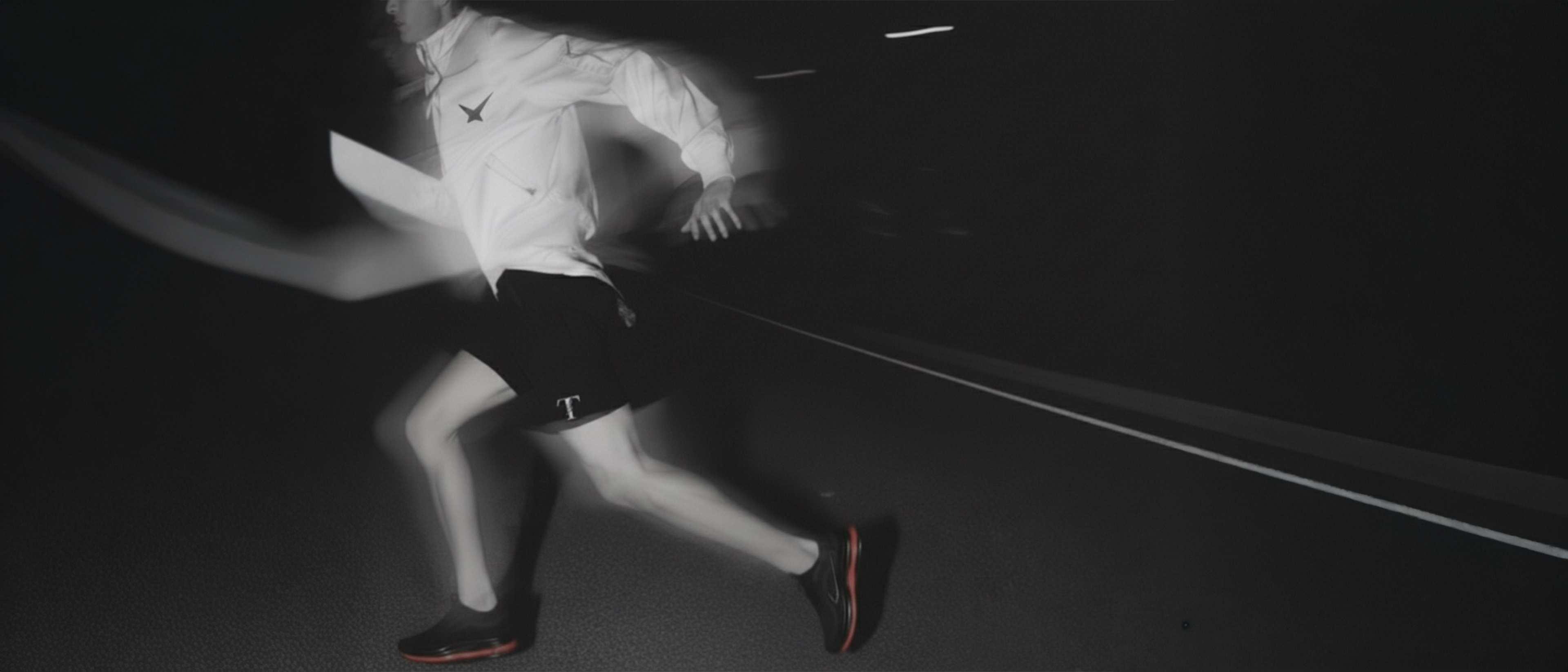 Person running on a dark road at night